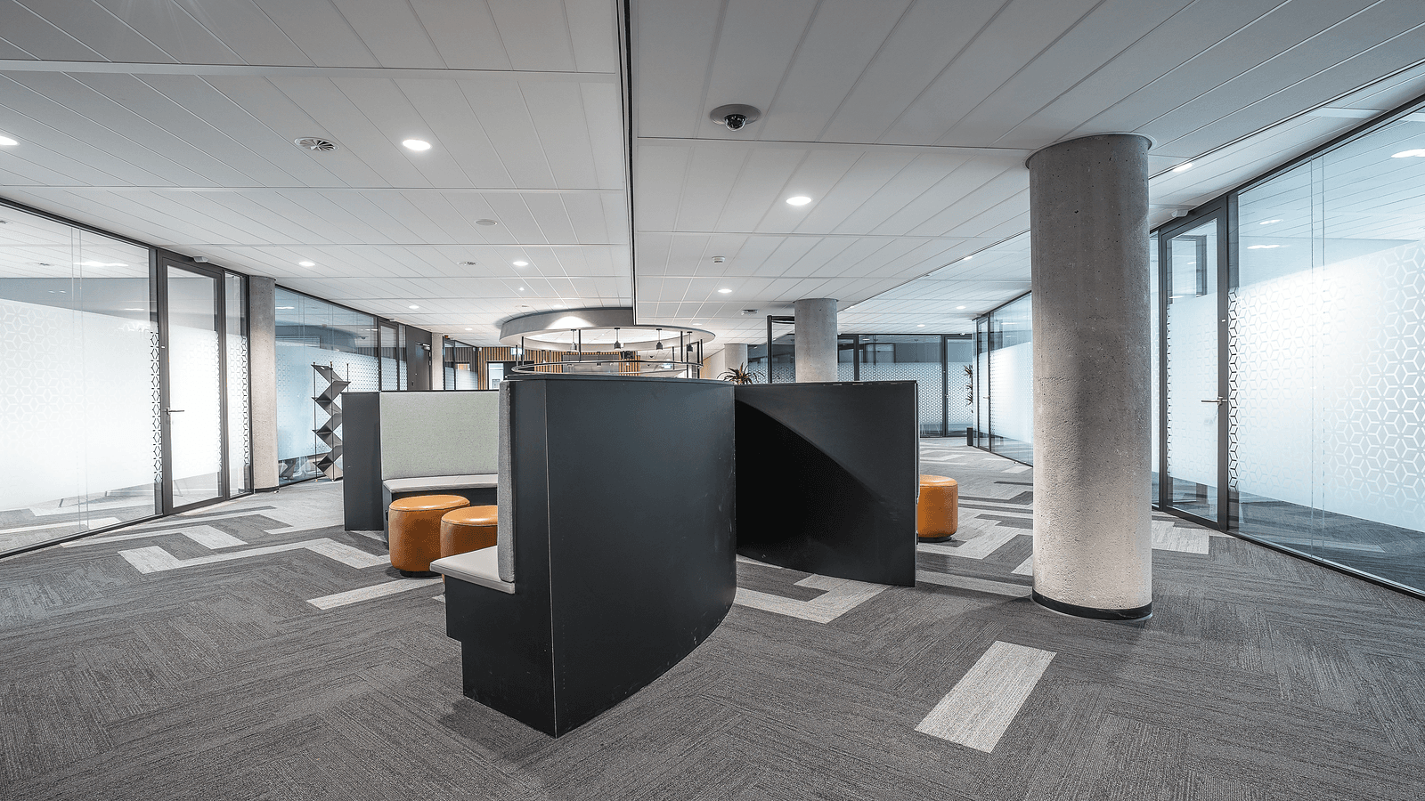 Modern software workspace with monitors and a quiet open plan